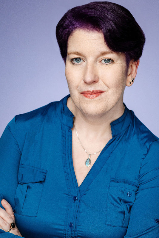 Woman wearing a blue shirt against a purple background